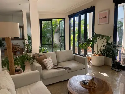 a living room with a couch and a table at Langikula Villa Seminyak Bali in Seminyak