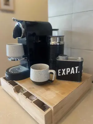 a coffee maker and cups sitting on a wooden shelf at Langikula Villa Seminyak Bali in Seminyak