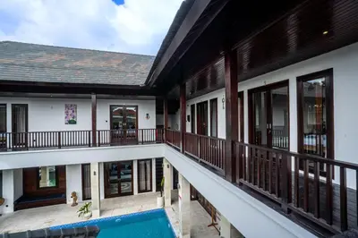 an external view of a house with a swimming pool at The Golden Serendipity Villa Seminyak in Seminyak