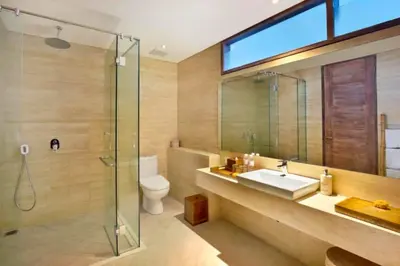 a bathroom with a sink and a glass shower at Sweet 3 BR Private Pool Villa Garden View in Kerobokan