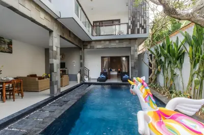 a pool with a water slide in a house at Taman Bali Villa Kerobokan in Kerobokan