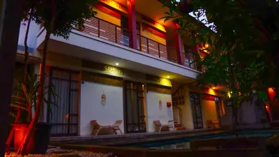 a building with a swimming pool at night at Dirga's House Sanur View by EPS in Sanur