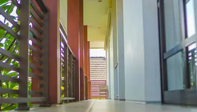 an empty hallway with a view of a building at Dirga's House Sanur View by EPS in Sanur