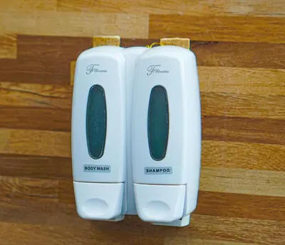 two white toasters sitting on top of a wooden floor at Dirga's House Sanur View by EPS in Sanur