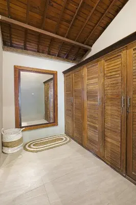 a room with wooden cabinets and a mirror at VILLA LA FELICITA in Seminyak