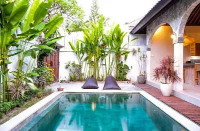 a swimming pool in the backyard of a house at VILLA LA FELICITA in Seminyak