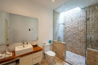 a bathroom with a toilet and a sink and a shower at Villa Chloe by Pertama Management in Seminyak