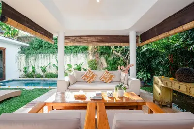a living room with a couch and a table at Villa Casa Coral at Umalas in Kerobokan