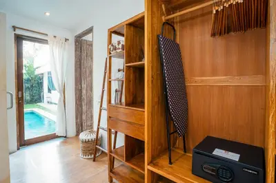 a room with a wooden book shelf with a speaker at Villa Casa Coral at Umalas in Kerobokan