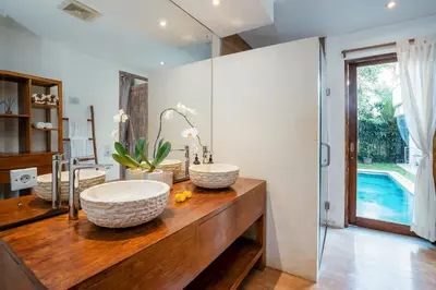 a bathroom with two sinks on a wooden counter at Villa Casa Coral at Umalas in Kerobokan