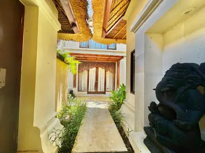 an empty hallway of a building with a hallway at Jimbaran Cozy Stay in Jimbaran
