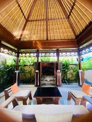 a living room with a couch and chairs and a fireplace at Jimbaran Cozy Stay in Jimbaran