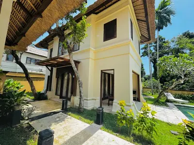 a house in the middle of a garden at Jimbaran Cozy Stay in Jimbaran