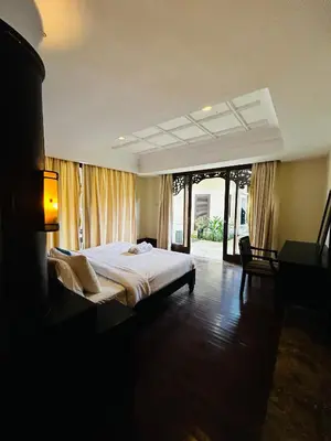 a bedroom with a large bed in a room at Jimbaran Cozy Stay in Jimbaran