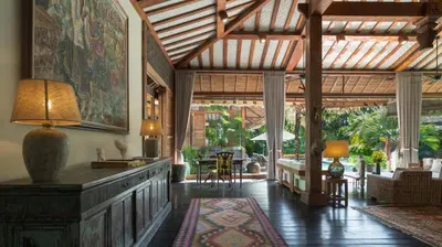 a living room with a large wooden ceiling at Desa Roro Estate by Villa Finder in Canggu