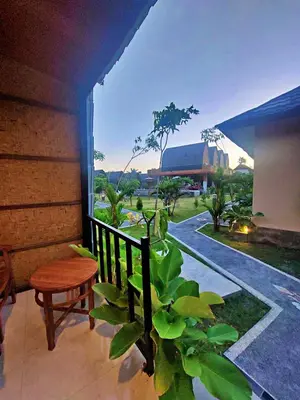 a porch with a bench and a plant and a building at Yogasari Villa Seminyak in Seminyak