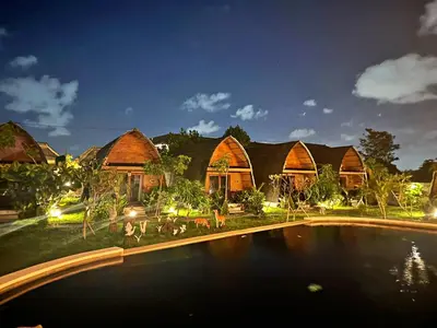 a house with a swimming pool in front of it at Yogasari Villa Seminyak in Seminyak