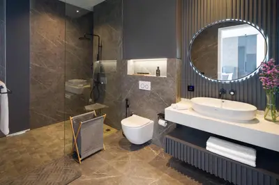 a bathroom with a sink and a toilet and a mirror at Umalas Creek Villas in Canggu
