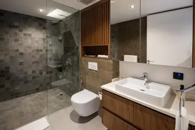 a bathroom with a sink and a toilet and a shower at Umalas Creek Villas in Canggu
