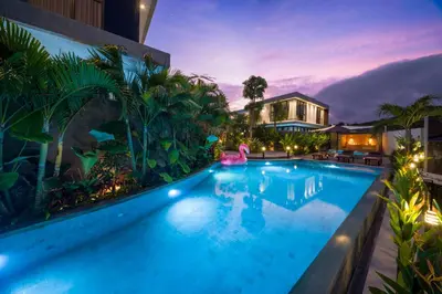 a swimming pool in a resort at night at Umalas Creek Villas in Canggu