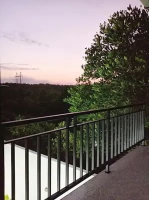 a balcony with a fence and a view of a field at Peaceful Private 4 BR YY Bali Villa, Jimbaran Nusa Dua, In Central Kuta in Jimbaran