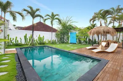 a swimming pool in a yard with palm trees at 3 Bedrooms Luxury Umalas with private pool in Kerobokan