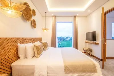 a bedroom with a large bed and a television at Brand New 4br Villa 400 to Finns Canggu in Canggu