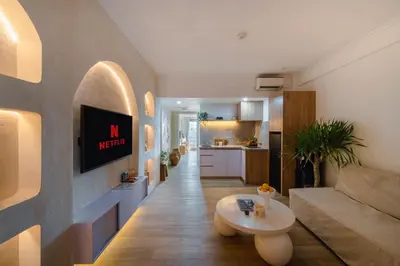 a living room with a couch and a table at Sunset Suites, 1 bed apartment, Jayakarta hotel in Seminyak