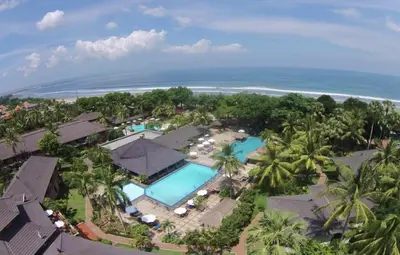 an aerial view of a resort with a pool and the ocean at Sunset Suites, 1 bed apartment, Jayakarta hotel in Seminyak