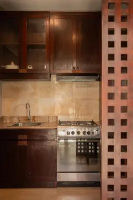 a kitchen with a stove and a sink at Bali Ula Villa in Nusa Dua