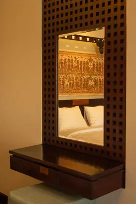 a mirror on a shelf with a bed in it at Bali Ula Villa in Nusa Dua