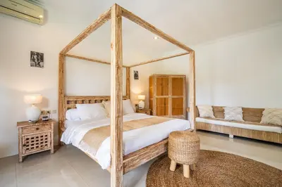 a bedroom with a large bed with a large mirror at Kupu-Kupu Villa by iBali Management in Canggu