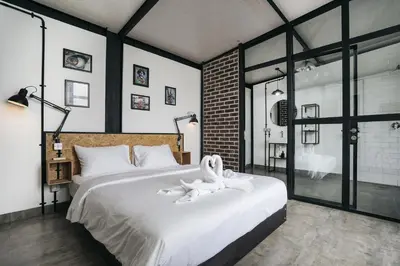 a bedroom with a large bed with a towel on it at Villa Costa Plana - 2 bedroom industrial private villa in Umalas, between Canggu & Seminyak in Seminyak