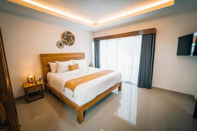 a bedroom with a large bed and a window at Villa Umah Seminyak in Seminyak
