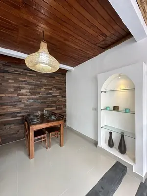 a room with a table with vases on a wall at Villa Umah Seminyak in Seminyak