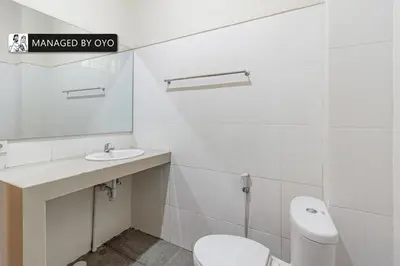 a bathroom with a toilet and a sink and a mirror at Collection O Near Seminyak Beach Formerly The Kumpi Hotel in Seminyak