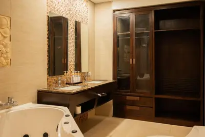 a bathroom with a bath tub and a sink and a tub at Bali Stile villa in Nusa Dua