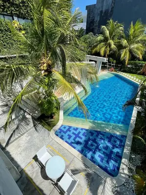 an overhead view of a swimming pool with a palm tree at Venus Private Pool Kuta By iLys Collection in Kuta