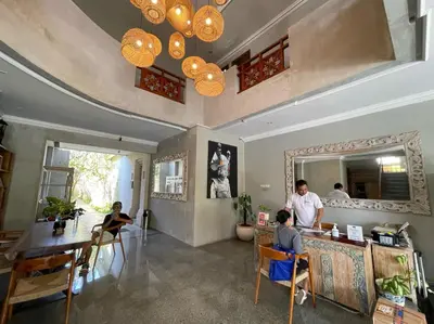 a group of people sitting at a counter in a room at Venus Private Pool Kuta By iLys Collection in Kuta