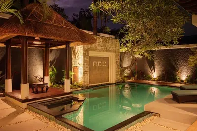 a swimming pool in a villa at night at Balinese stile villa in Nusa Dua