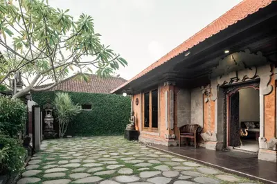 a courtyard of a house with a patio at Segara Beach House Villa - Kuta in Kuta