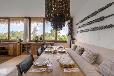 a dining room with a long table and chairs at Villa Casa Eldorado by BaliSuperHost in Kerobokan