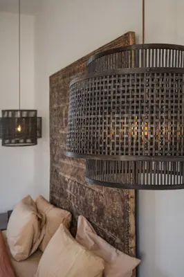 a large chandelier hanging over a couch with pillows at Villa Casa Eldorado by BaliSuperHost in Kerobokan