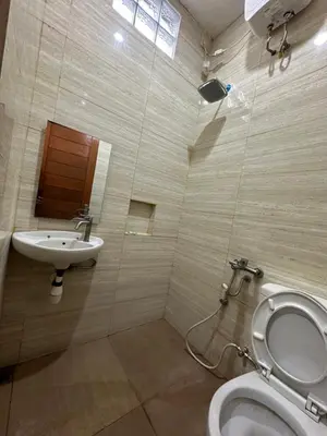 a bathroom with a toilet and a sink at Kubu Alvian Guest House in Seminyak