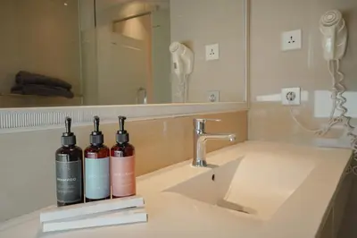 two bottles of wine sitting on a bathroom sink at Bustle Base Coliving and Coworking Space in Legian