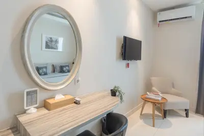 a room with a mirror and a table and a chair at Bustle Base Coliving and Coworking Space in Legian