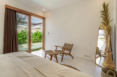 a bedroom with a bed and a balcony at Nooky 1 - 2BR Villa with HUGE Pool in Kerobokan