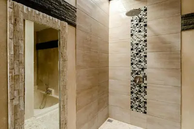 a bathroom with a shower with a tub and a mirror at 2 Bedroom Villa with Pool Seminyak with Car Park in Seminyak