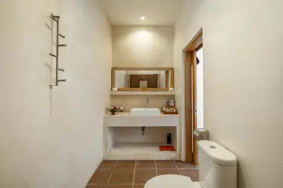 a bathroom with a sink and a toilet at Cozy 2 Bedroom Villa in Seminyak with private Pool in Seminyak
