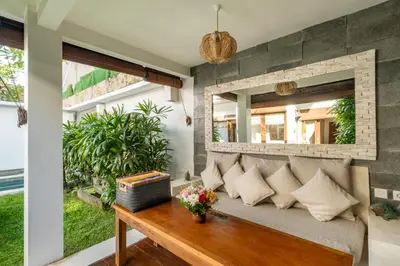 a living room with a couch and a window at Cozy 2 Bedroom Villa in Seminyak with private Pool in Seminyak